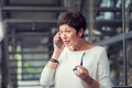 A mature woman talking at mobile phone stunned by what she hears Royalty Free Stock Photo