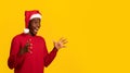 Shocking Offer. Amazed African Guy In Santa Hat Looking At Copy Space