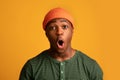 Shocking Offer. Closeup Portrait Of Amazed Black Hipster Guy In Orange Hat Royalty Free Stock Photo