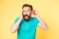 Shocking rumors. Man bearded mature guy eavesdrops with cup yellow background. Find out new scandalous rumors first. Guy Royalty Free Stock Photo