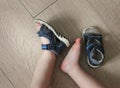 Shod legs of the baby. Children`s sandals on their feet. Toddler shoes. Tourist sandals for the smallest travelers. A new purchase Royalty Free Stock Photo
