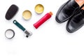 Shoe care products. Leather men shoes, shoe polish, brushes, wax on white background top view copy space