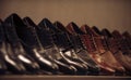 Shoe collection of black and brown leather on shelf. Mens shoes on display in shop. Footwear fashion and style. Shopping Royalty Free Stock Photo