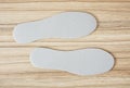 Shoe insoles on the wooden background Royalty Free Stock Photo