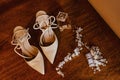 a shoe next to some jewels on a table by a piece of jewelry