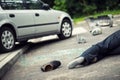 Shoe next to a victim of fatal car accident on the road Royalty Free Stock Photo