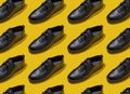 Shoe pattern. Black shoes on yellow background top view. Accessories concept. New leather shoes. Classic office Royalty Free Stock Photo