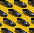 Shoe pattern. Black shoes on yellow background top view. Accessories concept. New leather shoes. Classic office Royalty Free Stock Photo