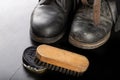 Shoe polish, brush and black military boots. Polishing and cleaning shoes on a black table Royalty Free Stock Photo