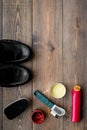 Shoe polish, brushes, wax near black shiny leather shoes on dark wooden background top view copy space Royalty Free Stock Photo