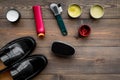 Shoe polish, brushes, wax near black shiny leather shoes on dark wooden background top view copy space Royalty Free Stock Photo