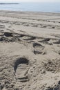 Shoe prints in the sand on a beach of the Mediterranean Sea