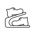 Shoe rack with boots. Linear icon of modern double storage. Black simple illustration of compact portable two-tier device for