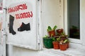 Shoe repair shop counter. Flower pots on the windowsill. Cozy exterior Royalty Free Stock Photo