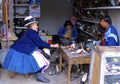 Shoe repairman. Native quechua woman. Peru