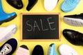 Shoe sale. Many different pairs of shoes for different seasons. a lot of shoes on yellow background, top view. Royalty Free Stock Photo