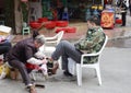 Shoe shiner at work Royalty Free Stock Photo