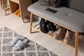 Shoe storage bench near grey wall in hallway, above view. Interior design Royalty Free Stock Photo