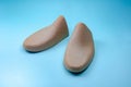 Shoe trees from recycled cardboard on blue background. Cardboard Shoe Inserts to keep Shape. Royalty Free Stock Photo