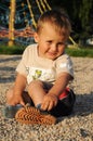 Shoeless child sitting on playground