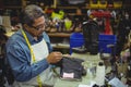 Shoemaker applying glue on shoe