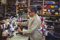 Shoemaker applying glue on shoe