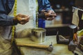 Shoemaker applying glue on shoe