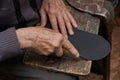 Shoemaker cuts rubber with a knife. Shoemaker retired. It works at home