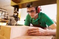 Shoemaker cutting and shaping wood to make shoe lasts