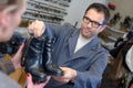 Shoemaker giving shoes back to customer