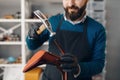 Shoemaker with hammer nails tips to the shoe