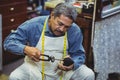 Shoemaker hammering on a shoe Royalty Free Stock Photo