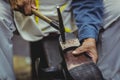 Shoemaker hammering on a shoe Royalty Free Stock Photo