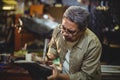 Shoemaker hammering on a shoe Royalty Free Stock Photo