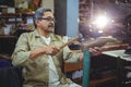 Shoemaker hammering on a shoe Royalty Free Stock Photo