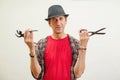 Shoemaker holding old cobbler tools in workshop. Small business concept