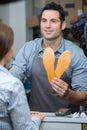 shoemaker holding shoe soles in workshop