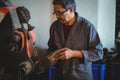 Shoemaker polishing a shoe with machine