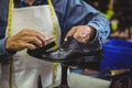 Shoemaker polishing a shoe