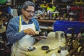 Shoemaker polishing a shoe