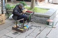 Shoemaker repairs shoes in the water town Wuzhen, China