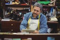 Shoemaker using digital tablet Royalty Free Stock Photo