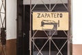 Shoemaker Zapatero in Spanish sign with sewing machine on a door in Havana, Cuba