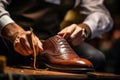 Shoemakers hands assembling fashionable mens leather shoes