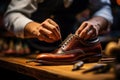 Shoemakers hands assembling fashionable mens leather shoes