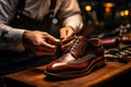 Shoemakers hands assembling fashionable mens leather shoes