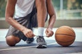 Shoes, basketball and sports with a man basket ball player tying his laces on a court before a game or match. Workout Royalty Free Stock Photo