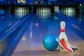 Bowling shoes and bowling balls yellow and blue on the background of the playing field Royalty Free Stock Photo