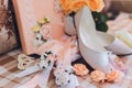 Shoes of the bride lie next to the wedding bouquet and gold wedding rings. Royalty Free Stock Photo