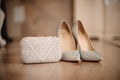 Shoes of the bride with shiny pebbles stand next to a white clutch Royalty Free Stock Photo